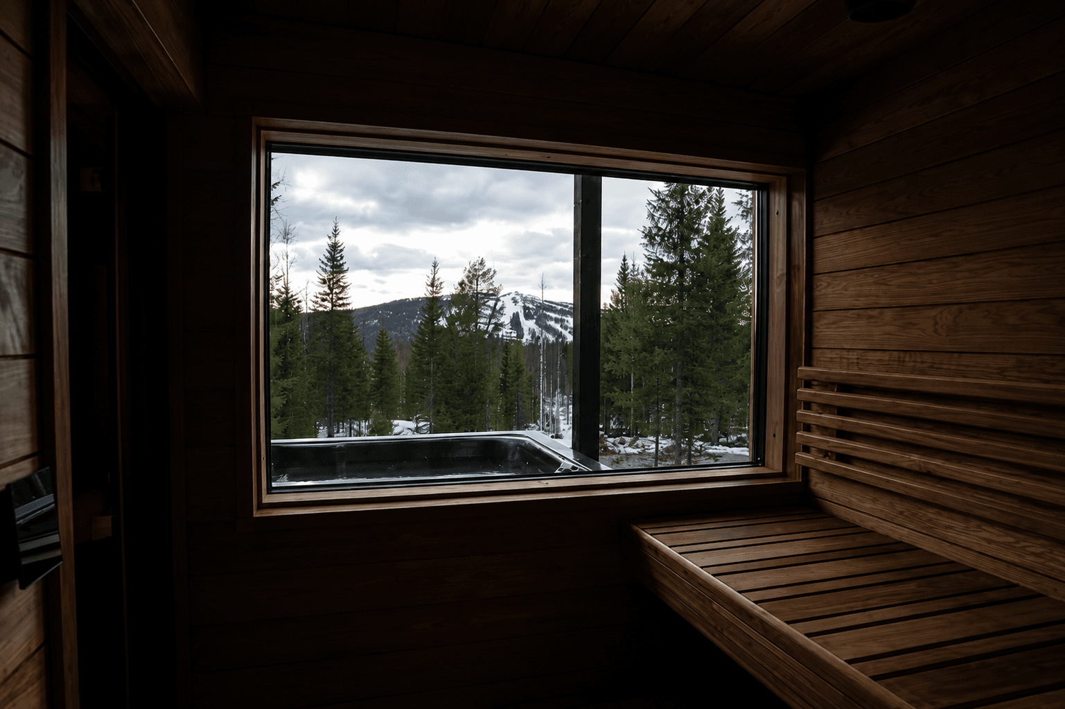 Näkymä Villa Rekin saunan ikkunasta poreammeeseen ja laskettelurinteeseen